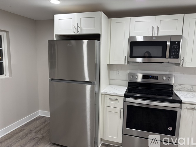 A kitchen with a stainless steel refrigerator and oven.