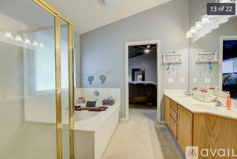 A bedroom with a bed and a vanity with a mirror.