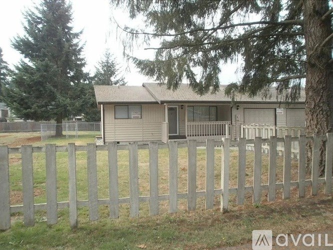 A house with a fence in front of it.