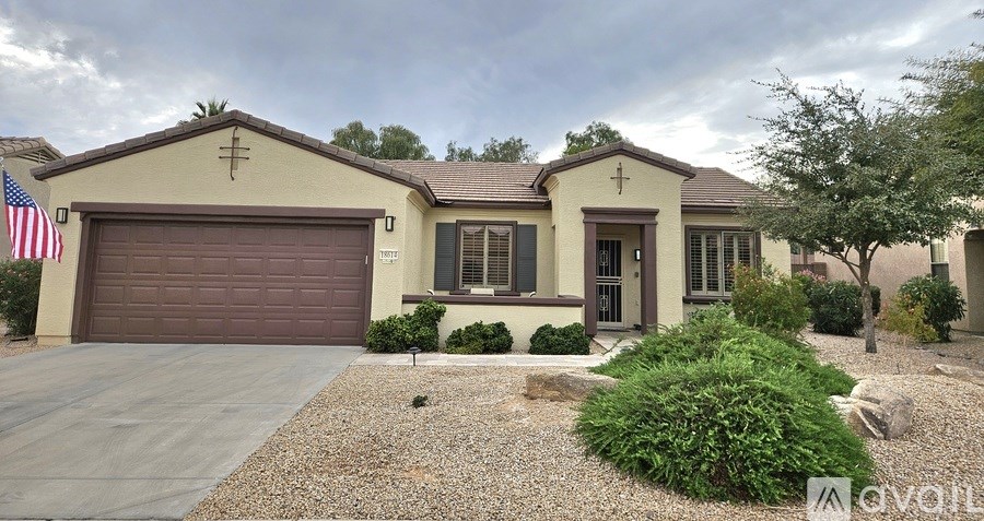 A house with a garage and a flag on the left side.