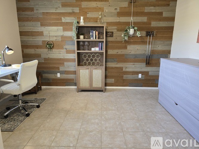 A room with a wooden wall and a white chair.