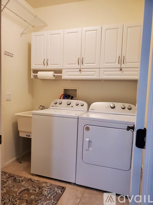 A small laundry room with a washer and dryer.