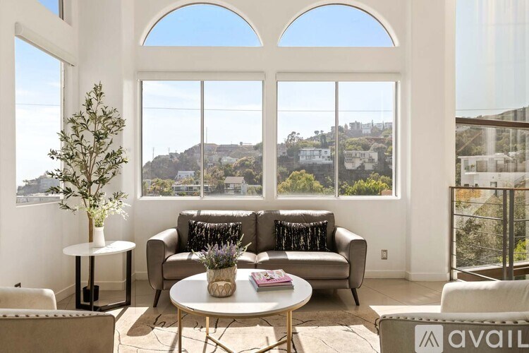 A cityscape at night with buildings illuminated and a clear sky.