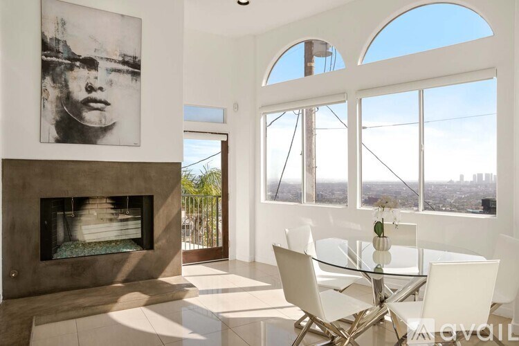 A modern living room with a fireplace and a blue chair.