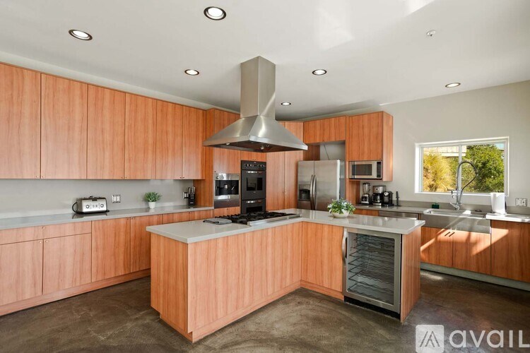 A white piano is in a room with a view of the city.