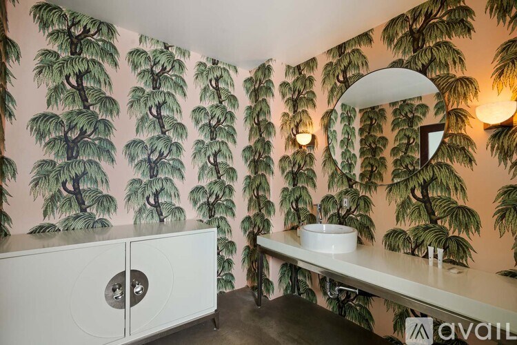 A balcony with a couch and pillows overlooking a city at night.