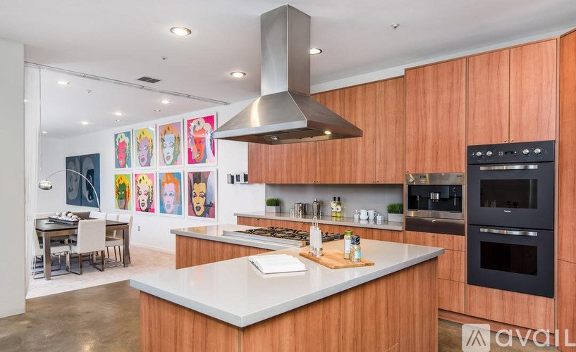 A modern kitchen with wooden cabinets and a white countertop.