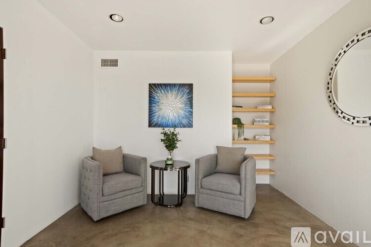 A hallway with wooden shelves on both sides and a door at the end.