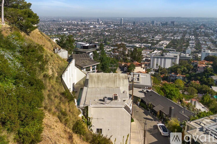 A modern white house with a balcony and a garage.