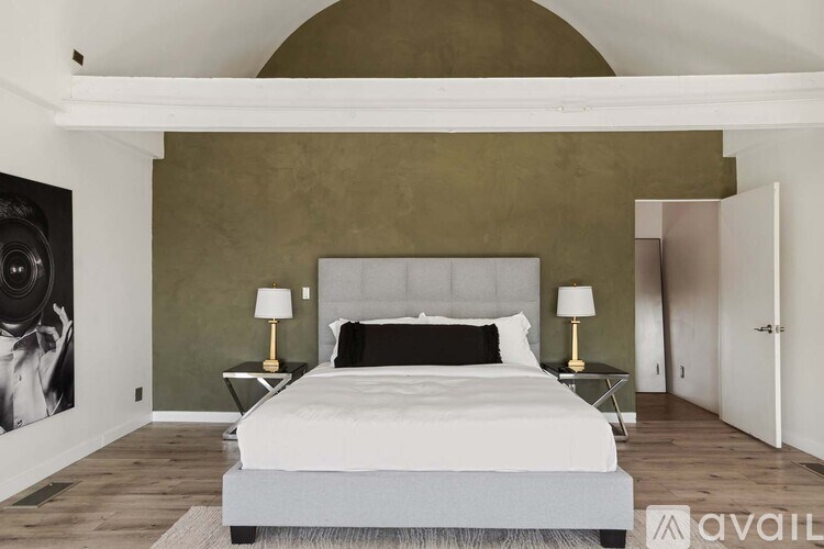 A bedroom with a large bed and a view of the city.