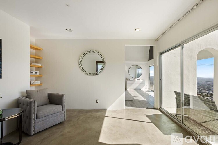 A bathroom with a marble patterned mirror and a large sink vanity.