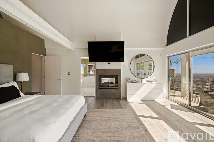 A bathroom with a wooden vanity and a glass shower stall.