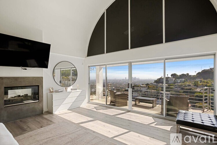 A white bathroom with a large tub and a chandelier.