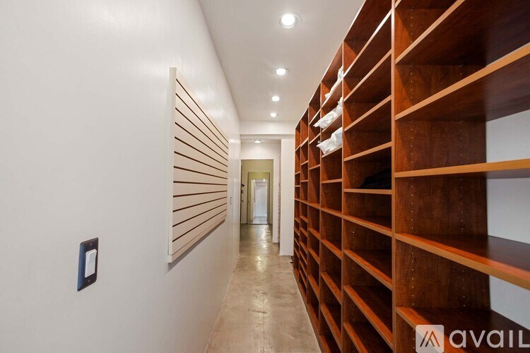 A modern bathroom with a large mirror, a fireplace, and a view of the city.