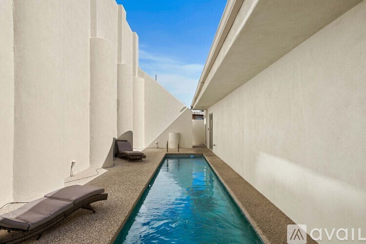 A bathroom with a white sink and toilet.