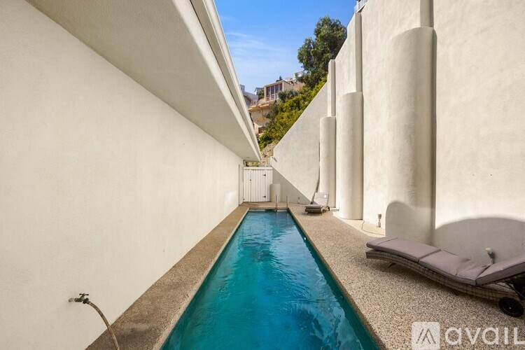 A bathroom with a large mirror, two sinks, and a walk-in shower.