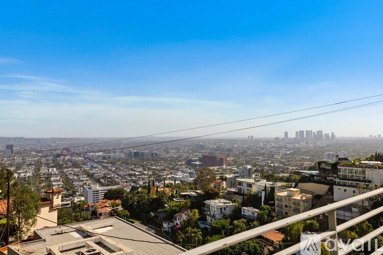 A pool in a patio area with chairs and a table.