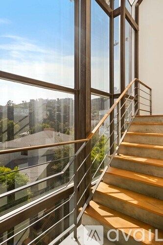 A staircase with a glass railing and wooden steps.