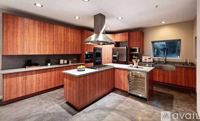 A modern kitchen with wooden cabinets and stainless steel appliances.
