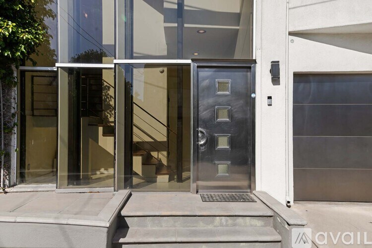 A modern house with a glass door and a metal handle.