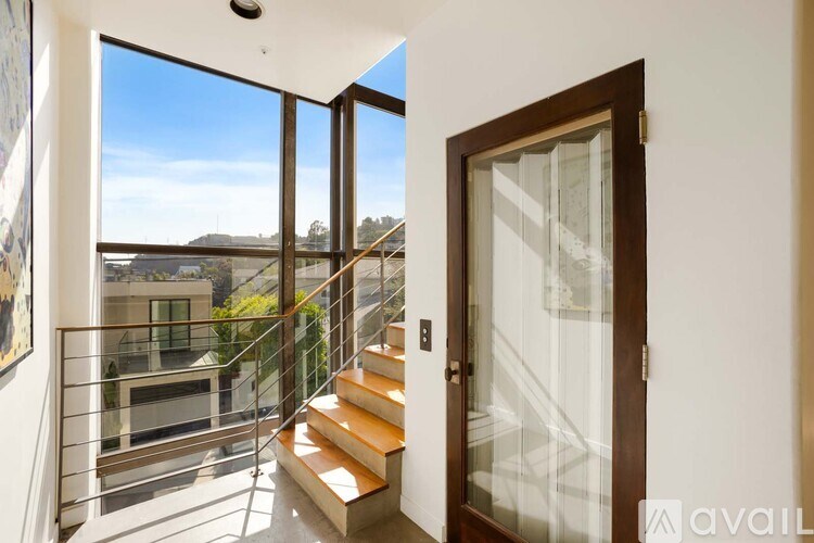 A bedroom with a large bed and a television on the wall.