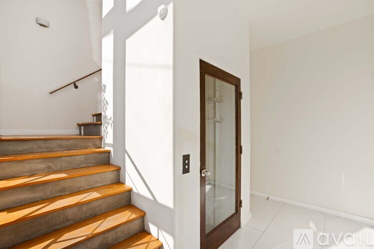 A modern bathroom with a large tub and a glass-enclosed shower.