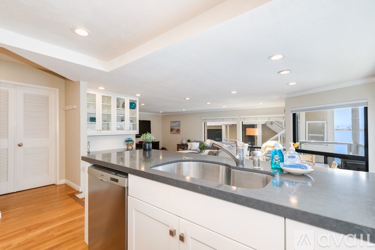 A kitchen with a sink and a dishwasher.