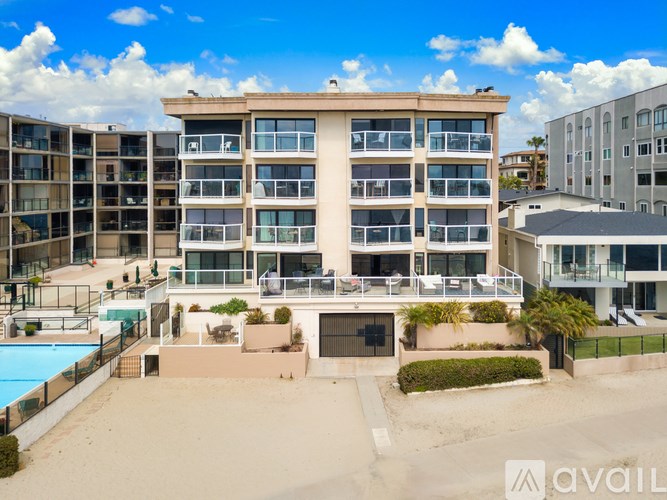 A large building with a pool in front of it.