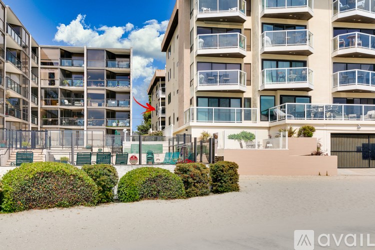 A building with a red arrow pointing to a balcony.