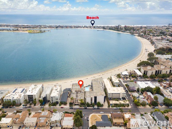 A beach is shown with a red marker on a building.