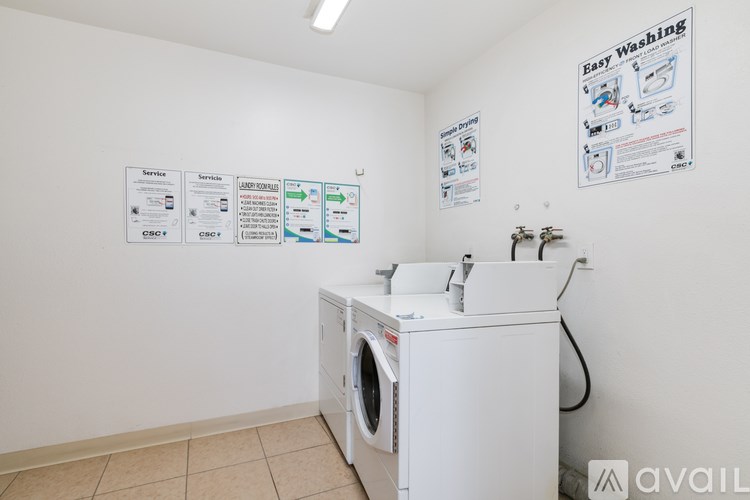 A wall of service notices and a washing machine in a laundromat.
