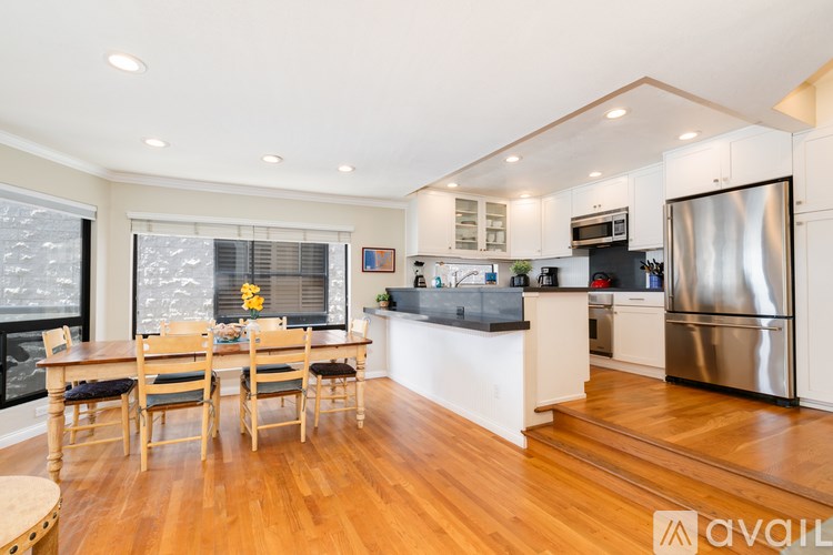 A kitchen with a dining table and chairs.