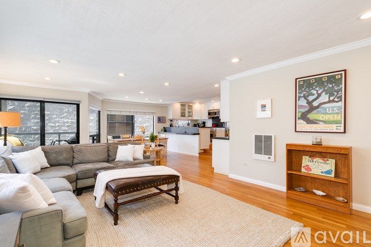 A living room with a grey sofa and a wooden coffee table.