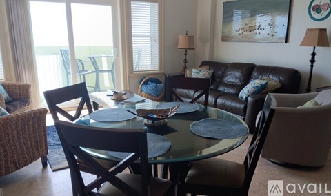 A living room with a glass table and chairs.