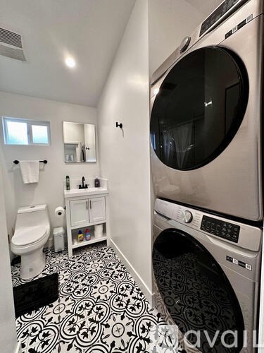 A modern laundry room with a washer and dryer.