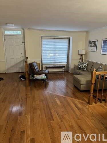 A living room with wooden floors and furniture.