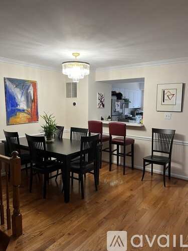 A dining room with a table set for four.