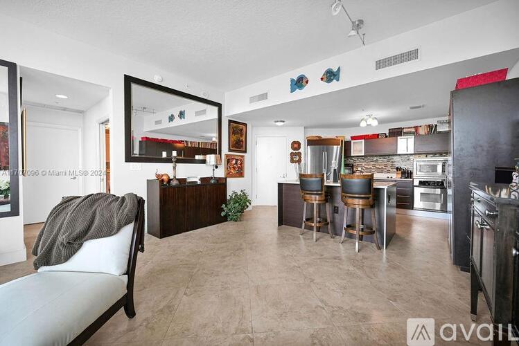 A modern kitchen with a dining table and chairs.