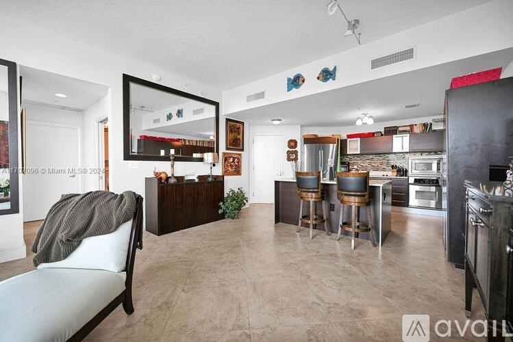 A modern kitchen with a dining table and chairs.