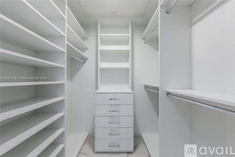 A white closet with shelves and drawers.