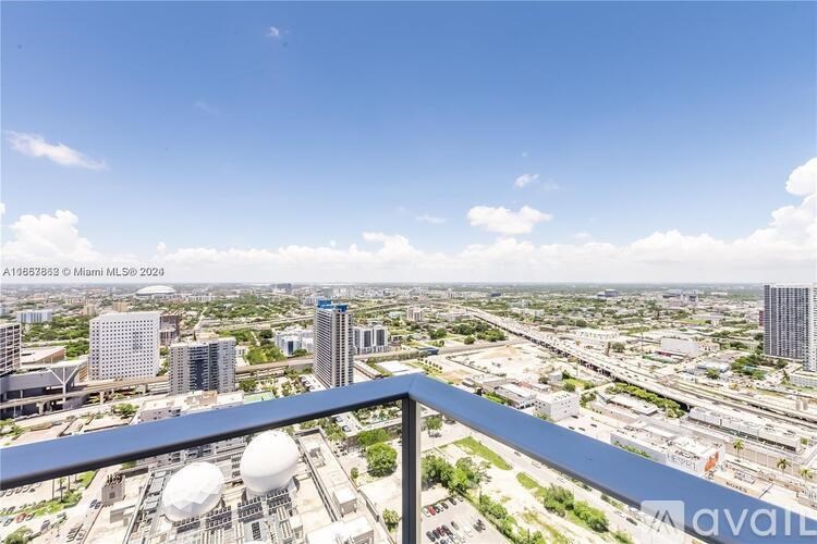 A cityscape with a clear blue sky and a few clouds.