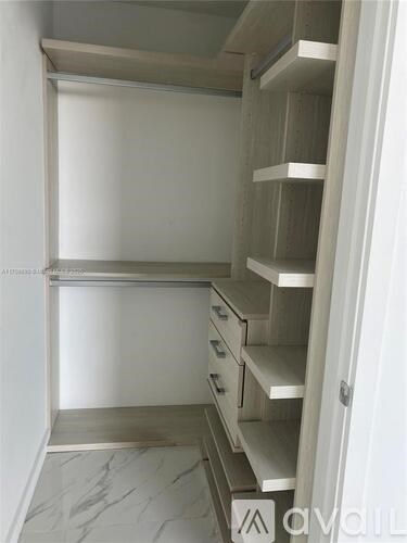 A kitchen with white cabinets and drawers.