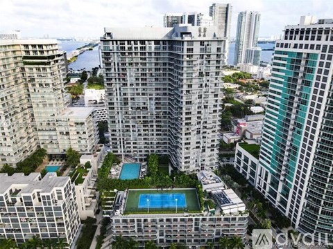 A tall building with a pool in the middle of it.
