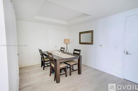 A dining room with a wooden table and chairs.