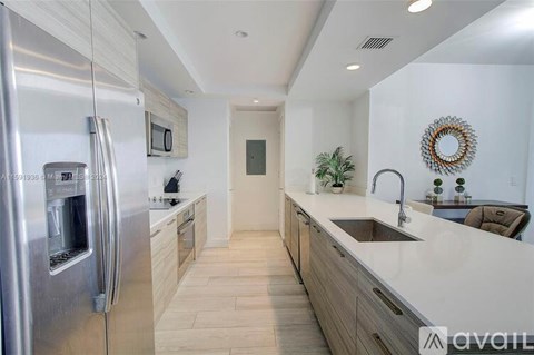 A modern kitchen with a stainless steel refrigerator and wooden cabinets.
