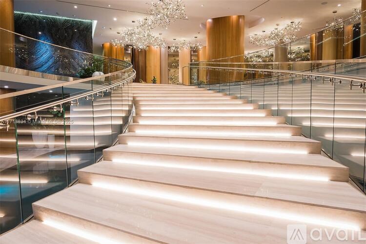 A staircase with wooden steps and a glass railing.