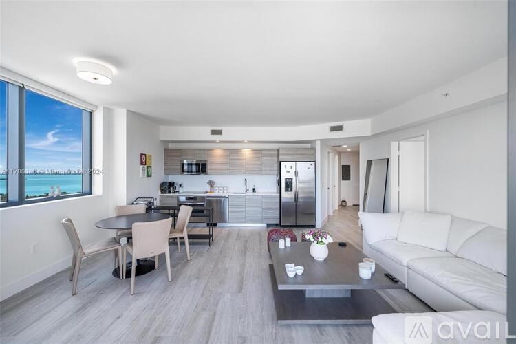 A modern living room with a dining table and chairs.
