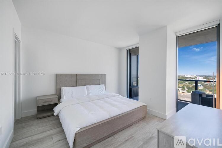 A bedroom with a large bed and a view of the city.