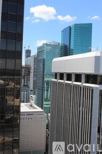 A cityscape with tall buildings and a clear sky.