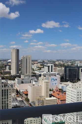 A cityscape with tall buildings and a clear sky.